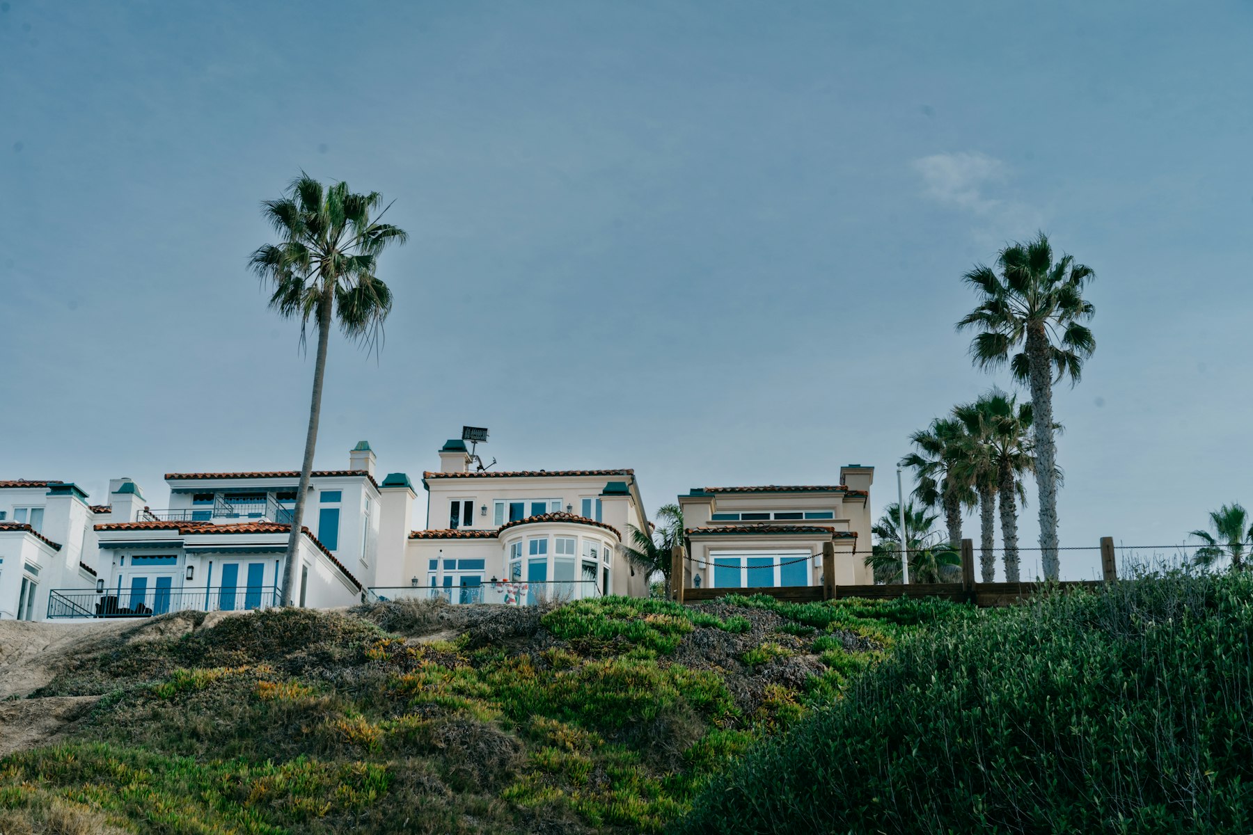 Luxury coastal home exterior with sweeping deck